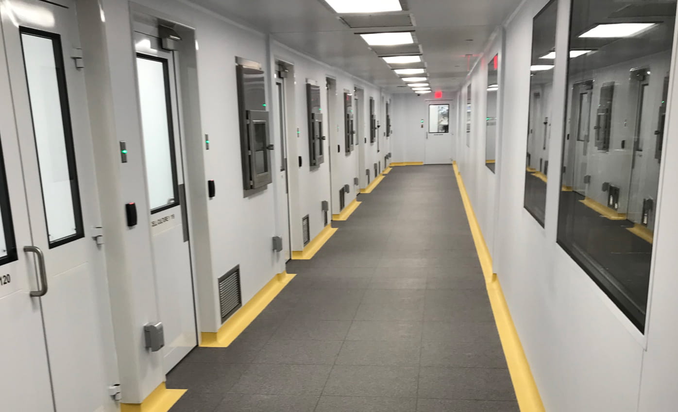 Inside a POD cleanroom hallway showing multiple room doors